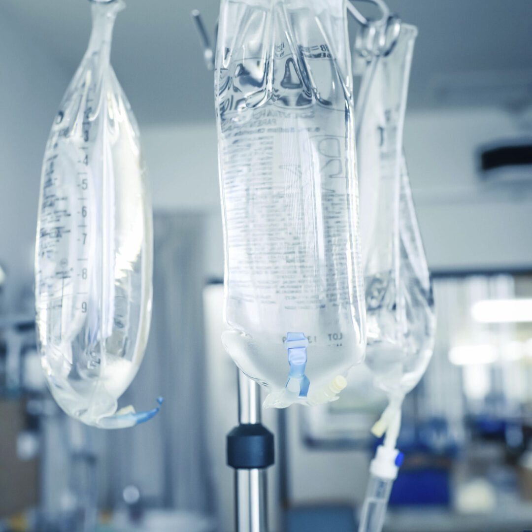 IV bags hanging in a hospital room.